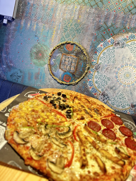 Freshly baked pizza with various toppings on decorative table