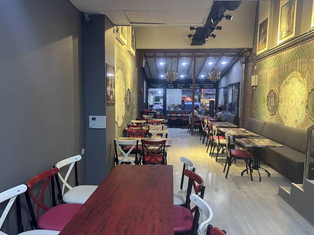 Modern interior dining area with red chairs and warm lighting