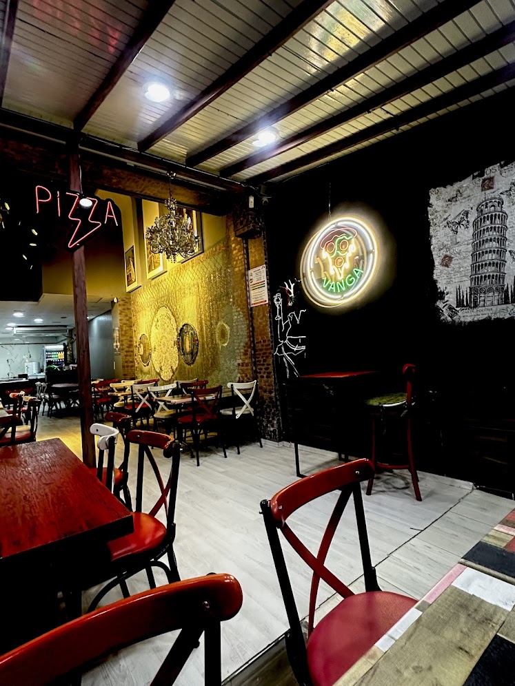 Cozy restaurant atmosphere with neon pizza sign and Italian decor